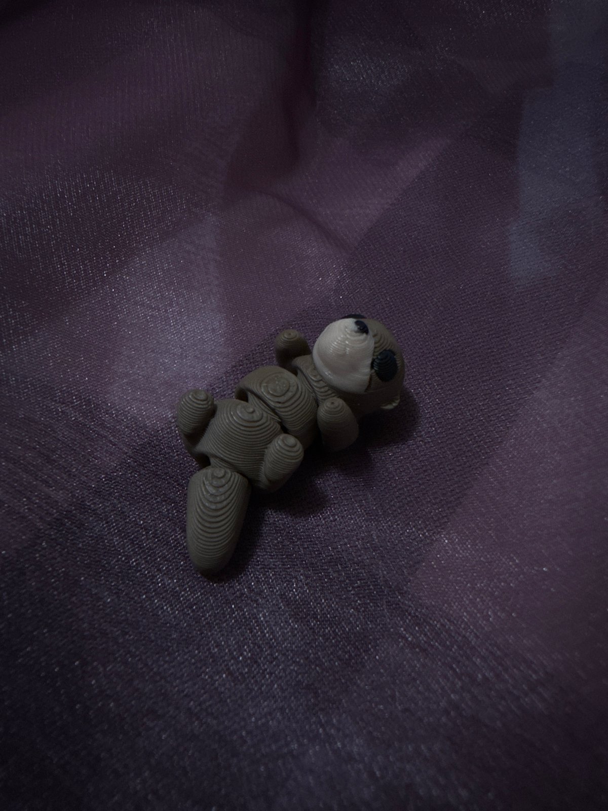 3D-printed toy bear photographed on fabric in Puebla