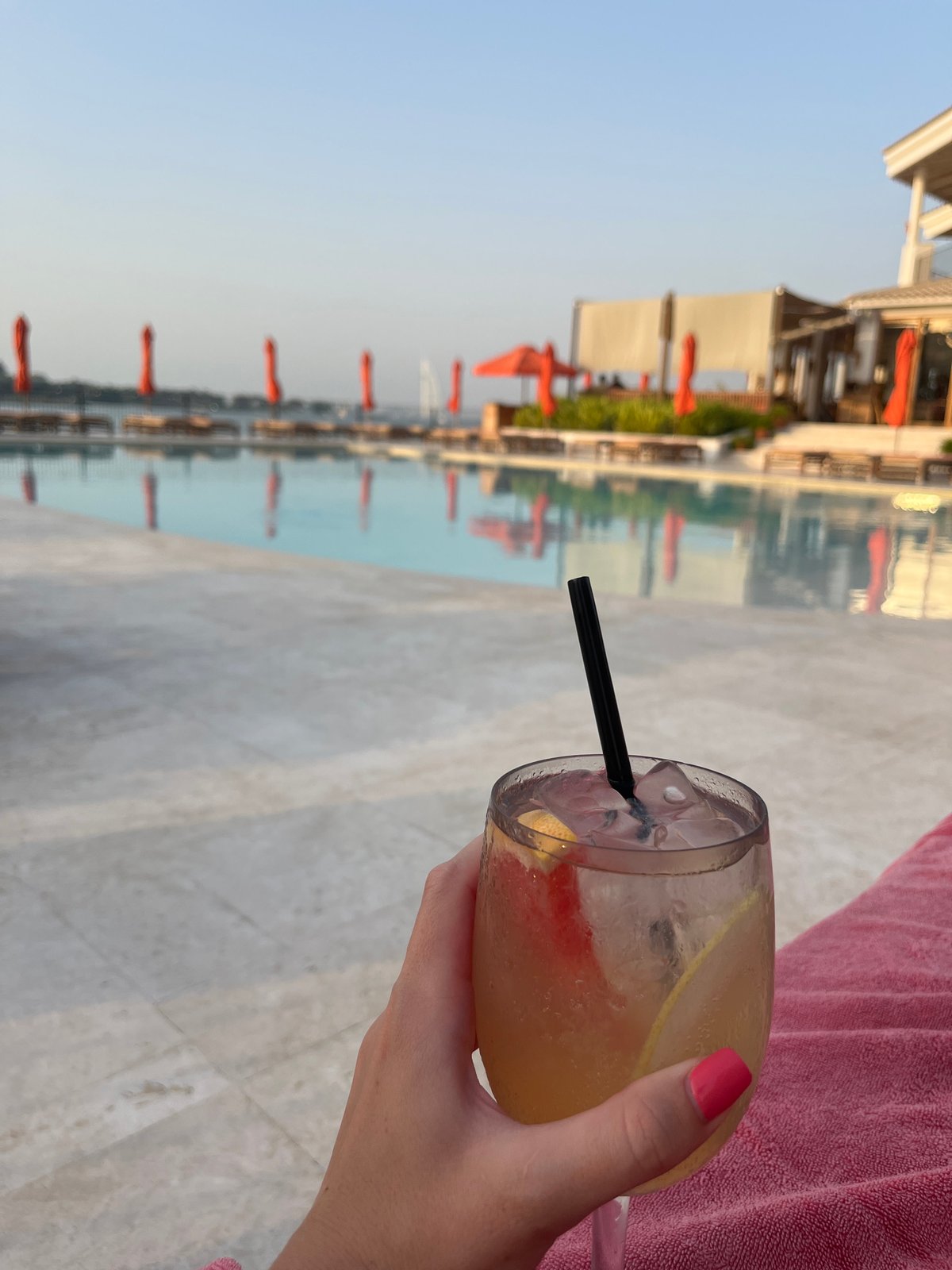 Drinks and loungers at a Dubai pool midday