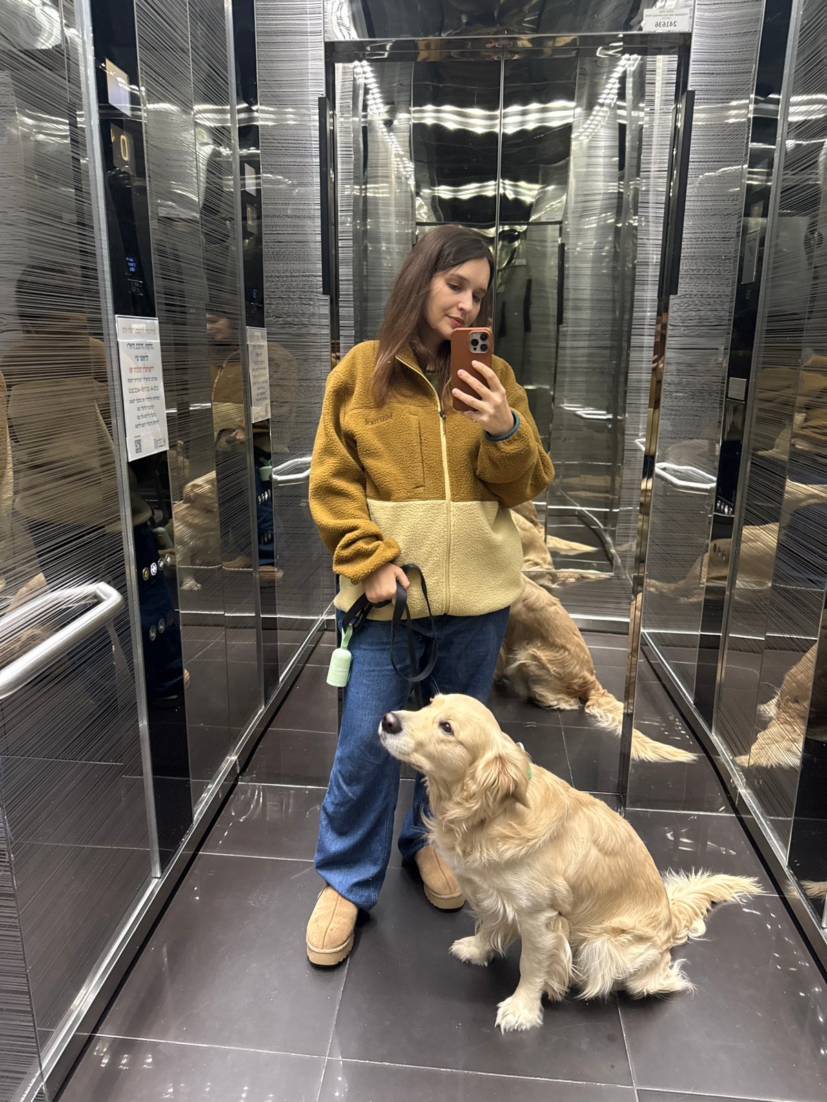 Woman takes selfie in mirrored elevator in Tel Aviv