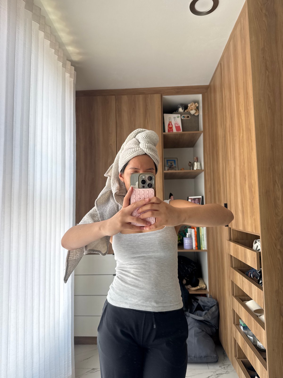 Person takes mirror selfie with towel in Puebla