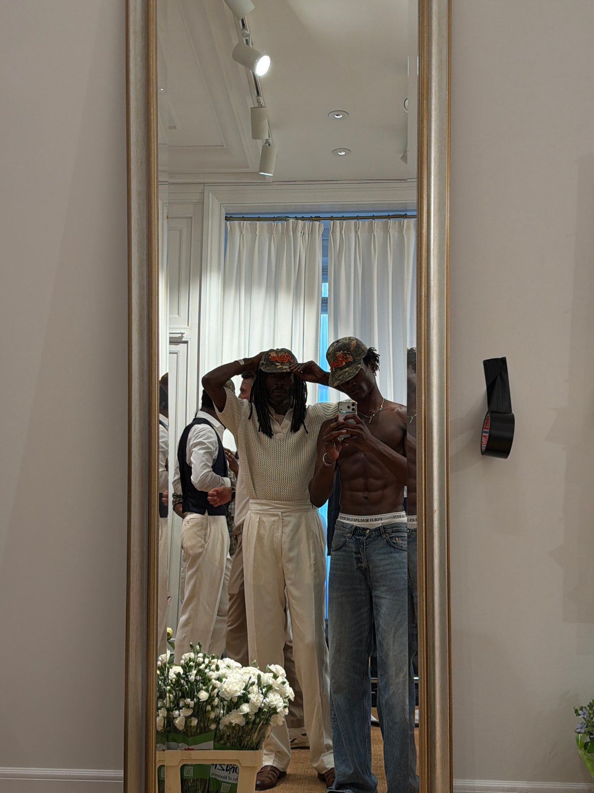 Inside a Milan fashion event, phones up and people gathered