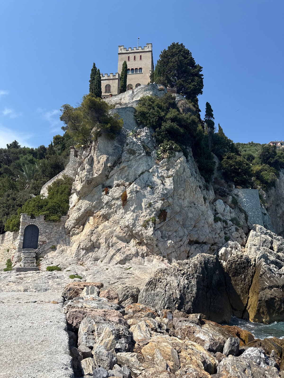 Sun, pebbles, and a clifftop castle on the Ligurian coast
