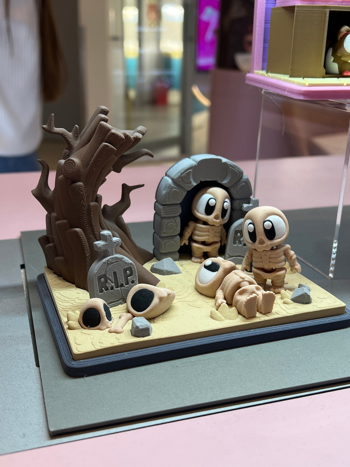 3D-printed graveyard diorama with skeletons displayed in Khimki