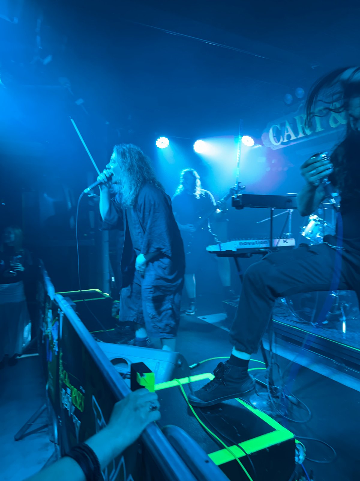 Live music performance captured under blue stage lights