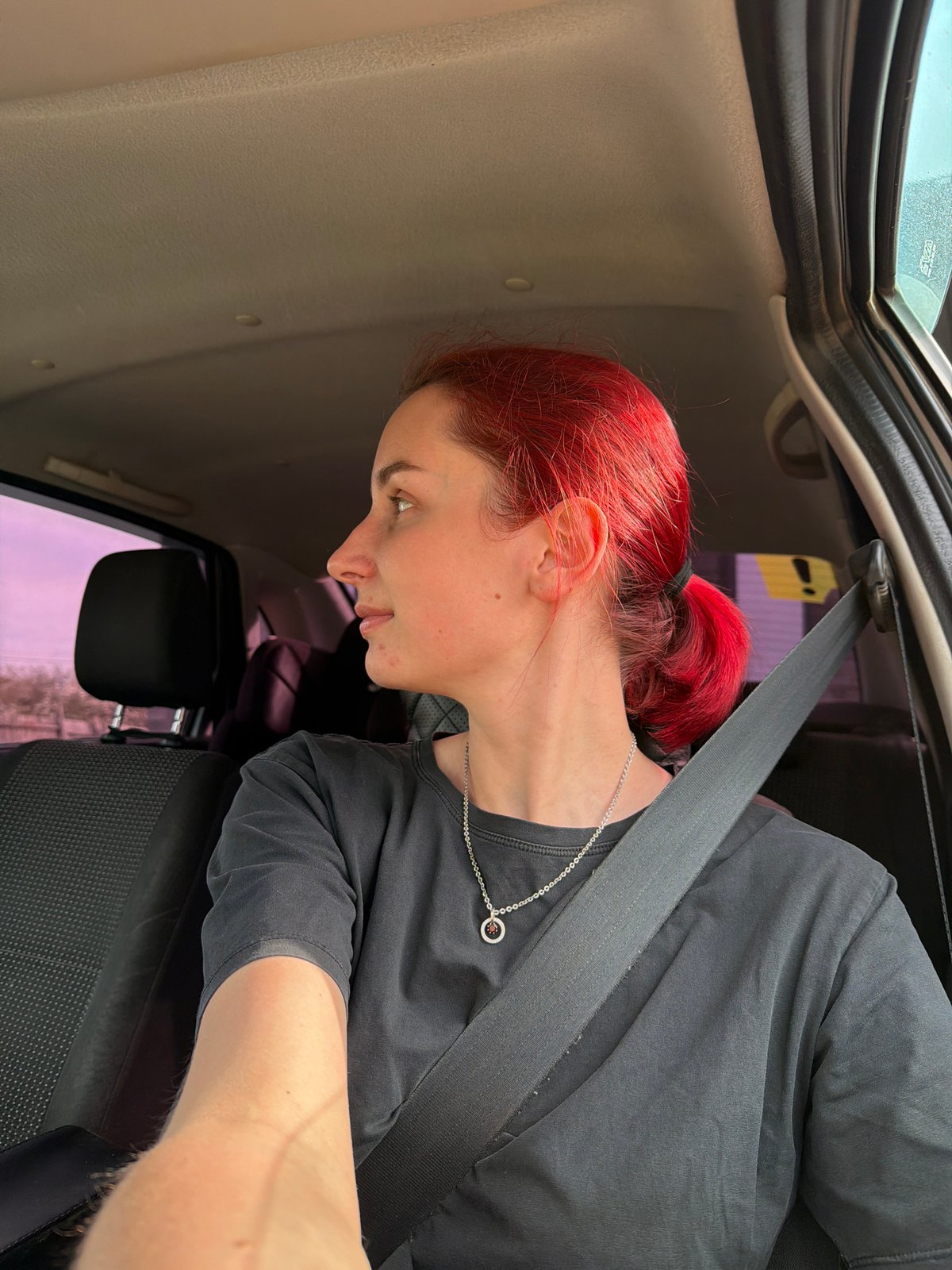 Red-haired woman observed in vehicle interior in Chaikovsky