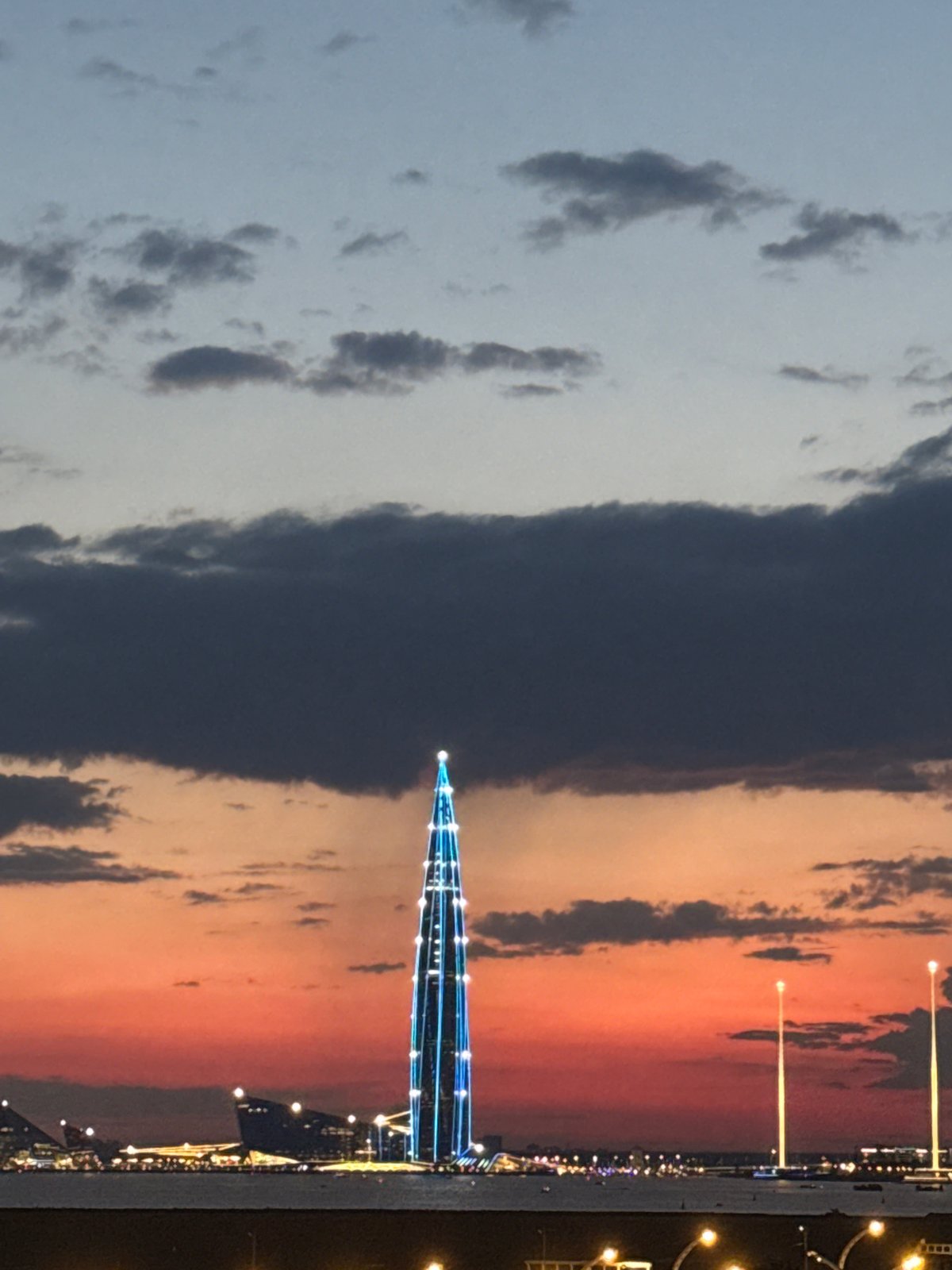 Lakhta Center and Gazprom Arena glow through a Saint Petersburg twilight