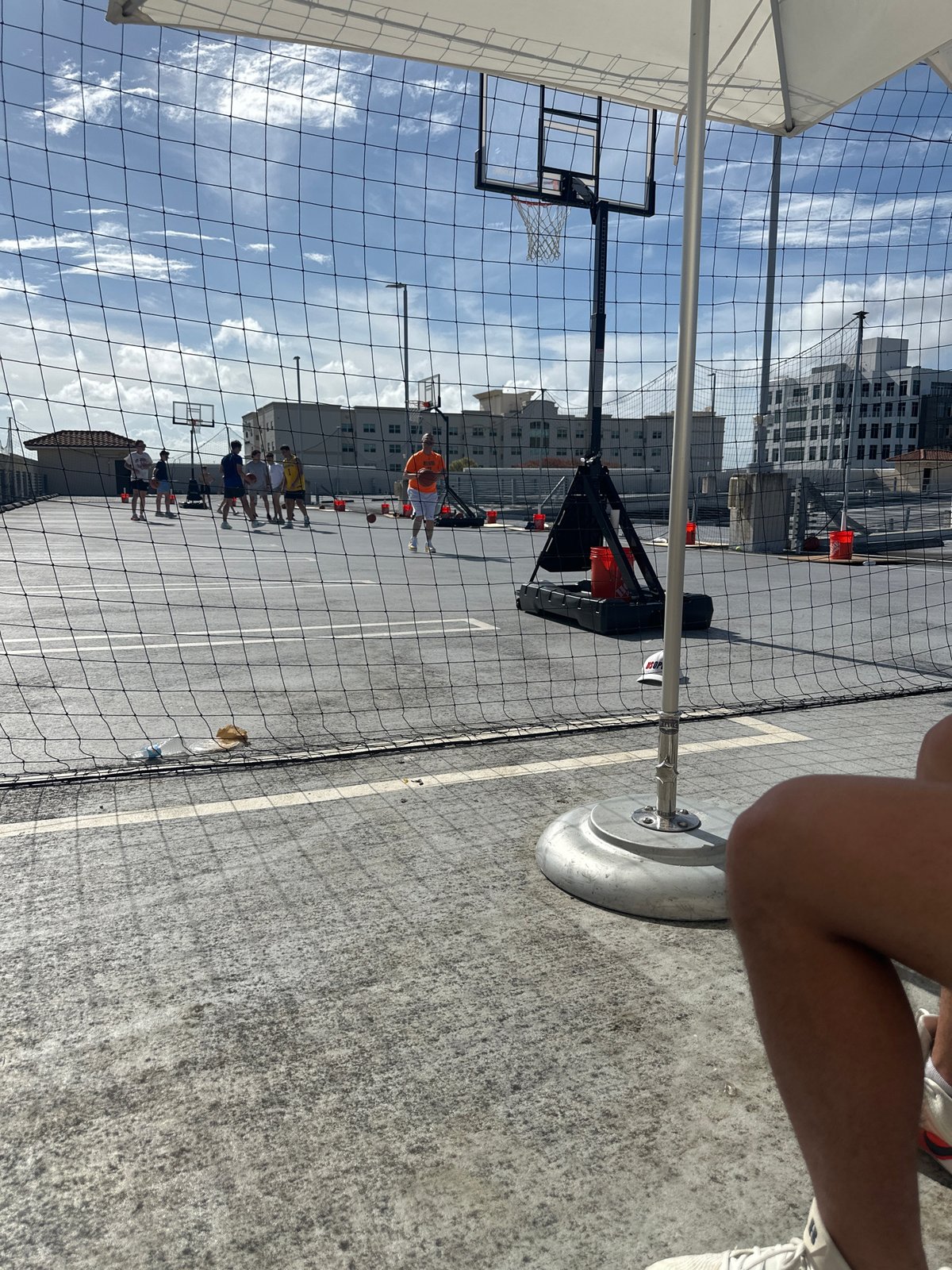 Evening basketball game observed on outdoor court in Aventura