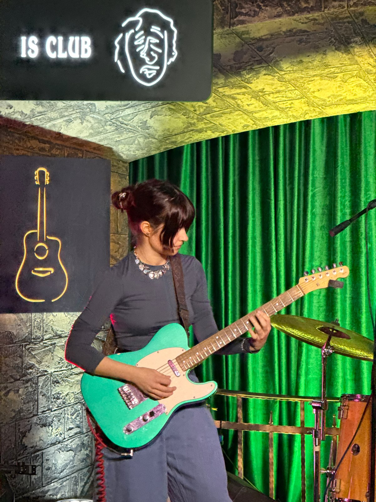 Live band performance featuring female guitarist at Moscow club