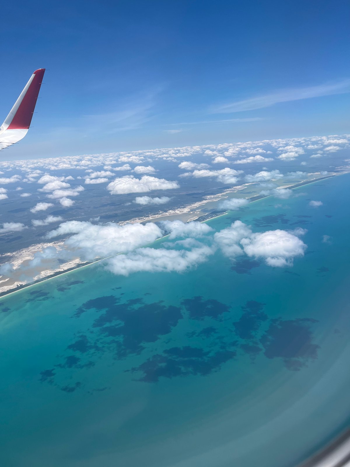 Aerial view captures tropical Mexican coastline from airplane window
