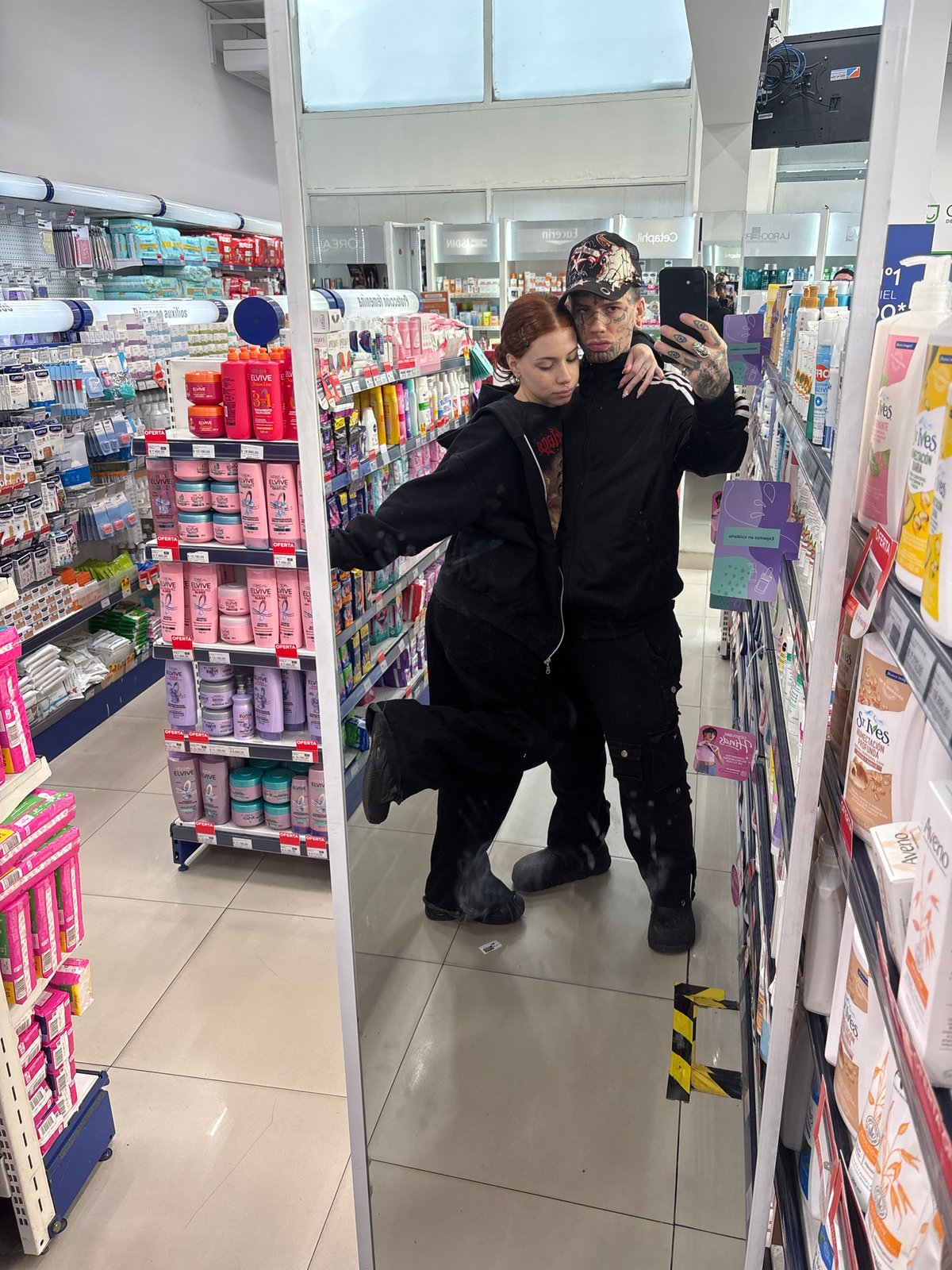 Two people take selfie in Buenos Aires store aisle