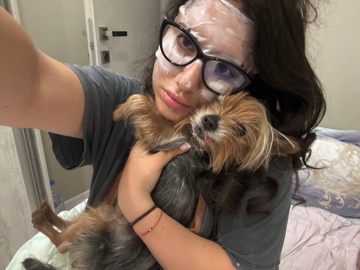 Woman documents evening skincare routine with pet in Burgas
