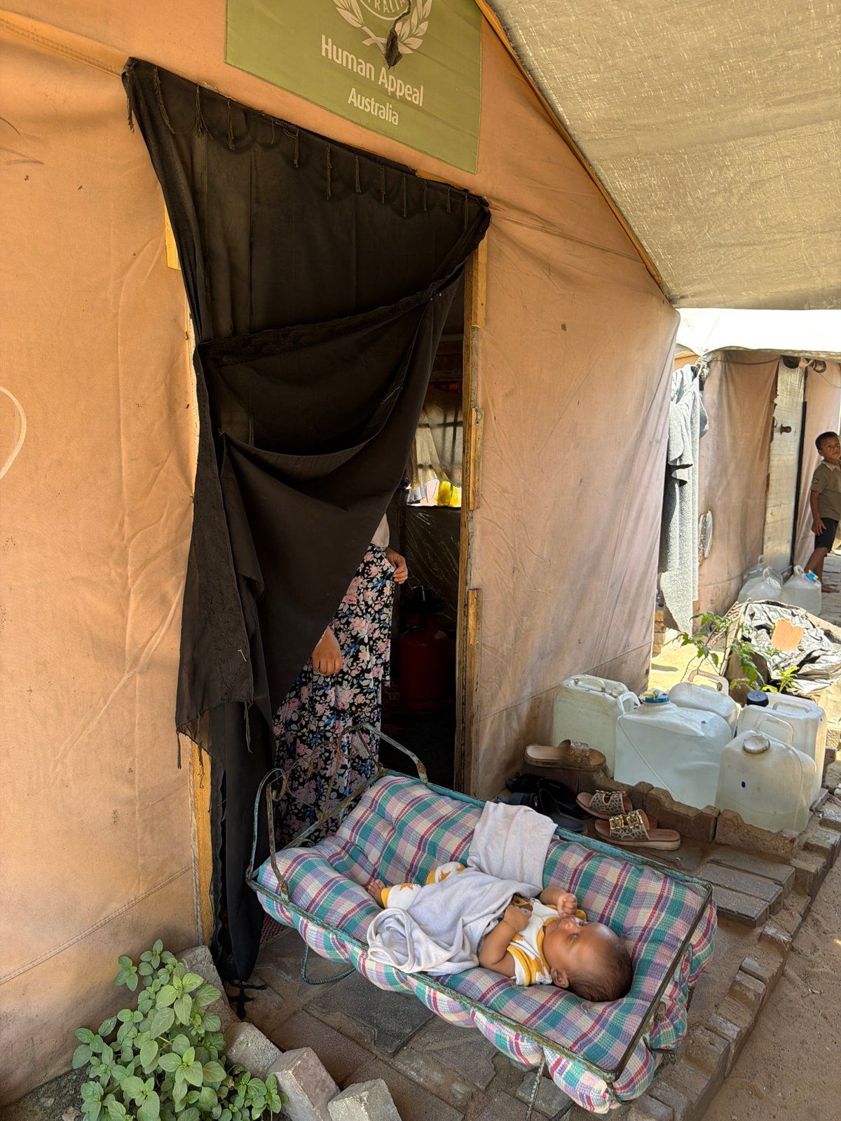 Canvas and tarp shelter under bright sun in Gaza