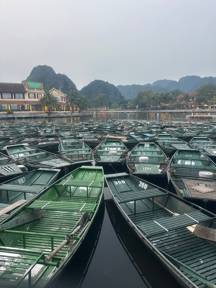 Dense cluster of wooden boats crowds Vietnam waterway