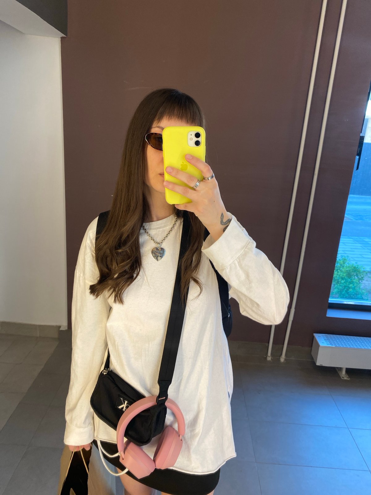 Person takes mirror selfies in Izhevsk apartment building corridor