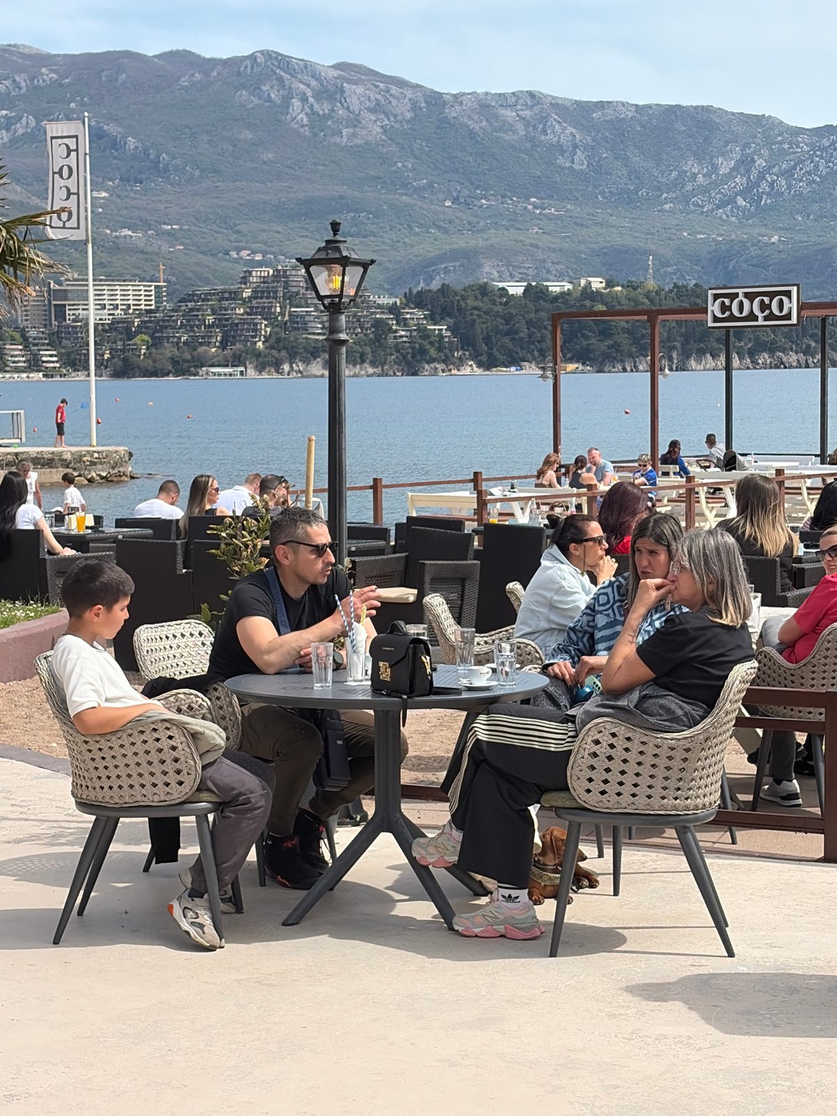 Tourist poses for photos at Budva waterfront Montenegro