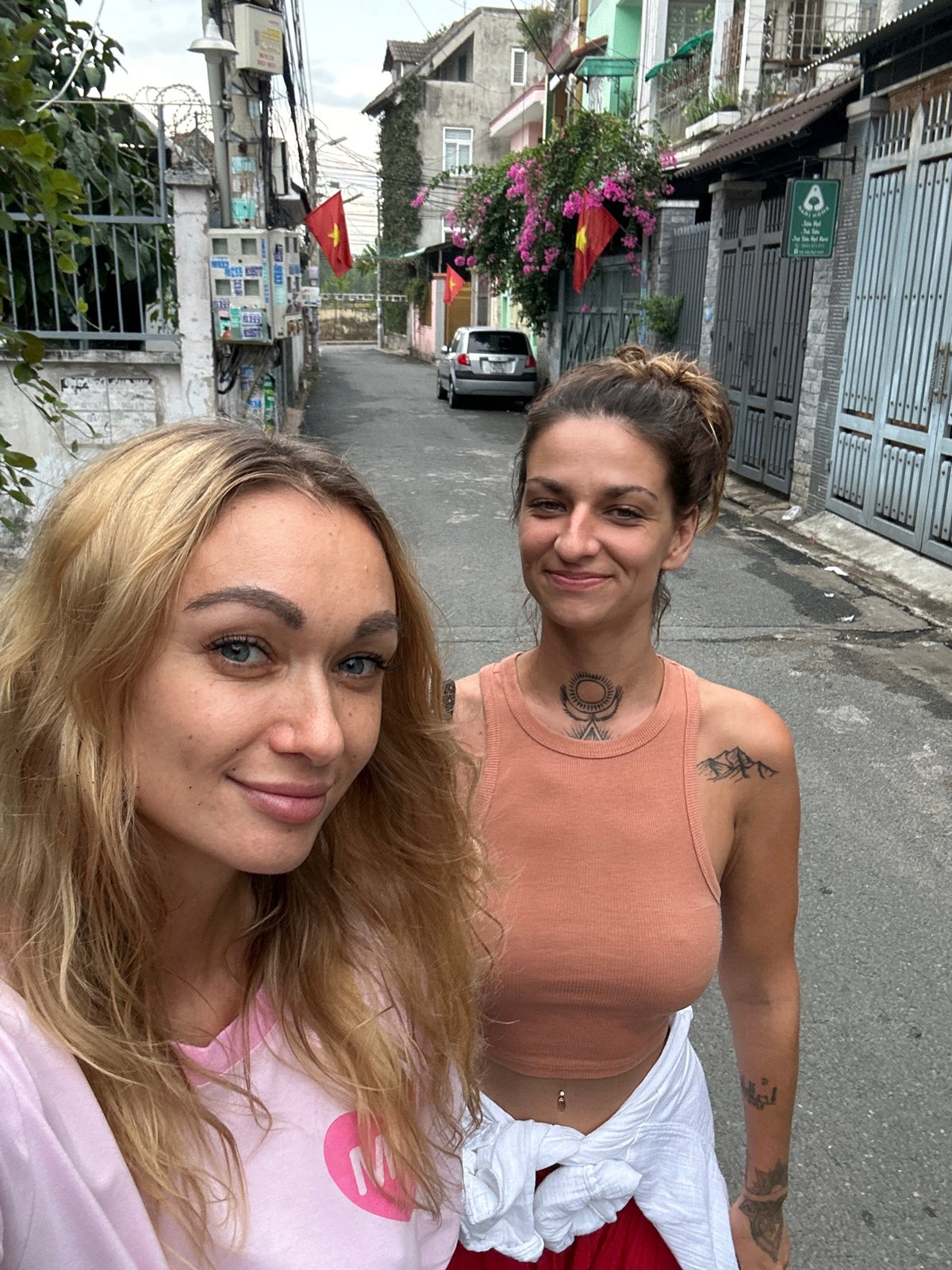 Two women take selfie on street in Vietnam