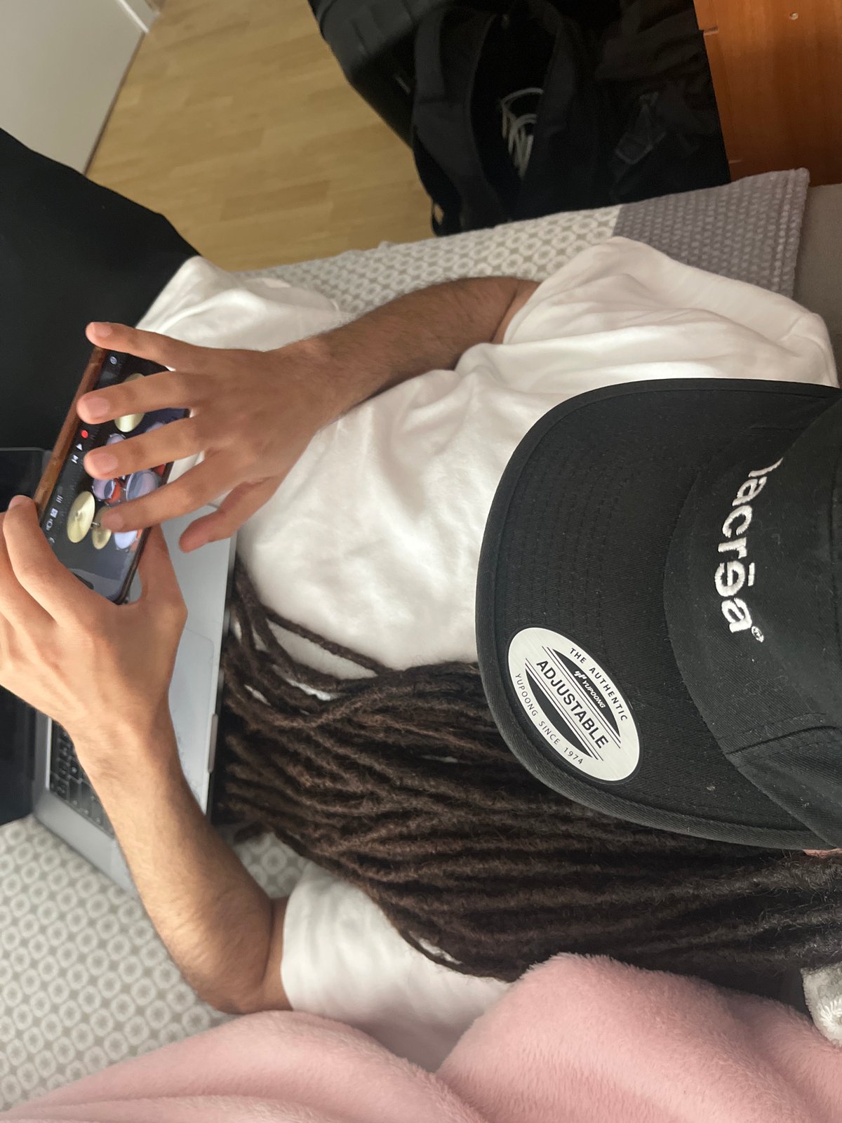 Person with dreadlocks rests indoors in A Coruña