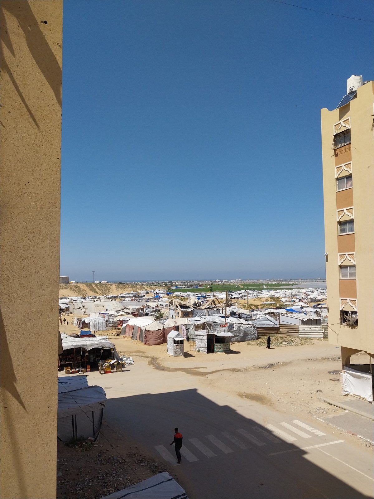 Aerial views capture refugee camp and damaged building