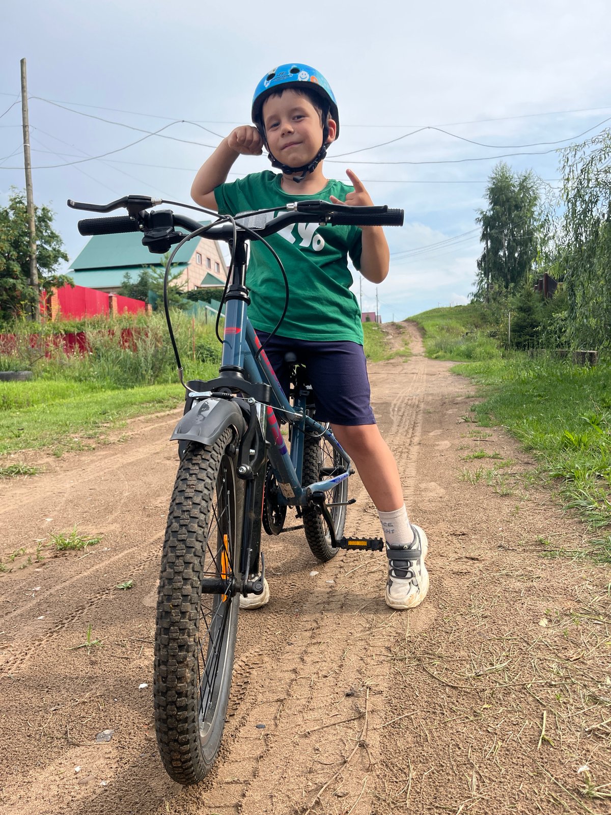 Helmeted cyclists pause on a dirt road in Chaikovsky