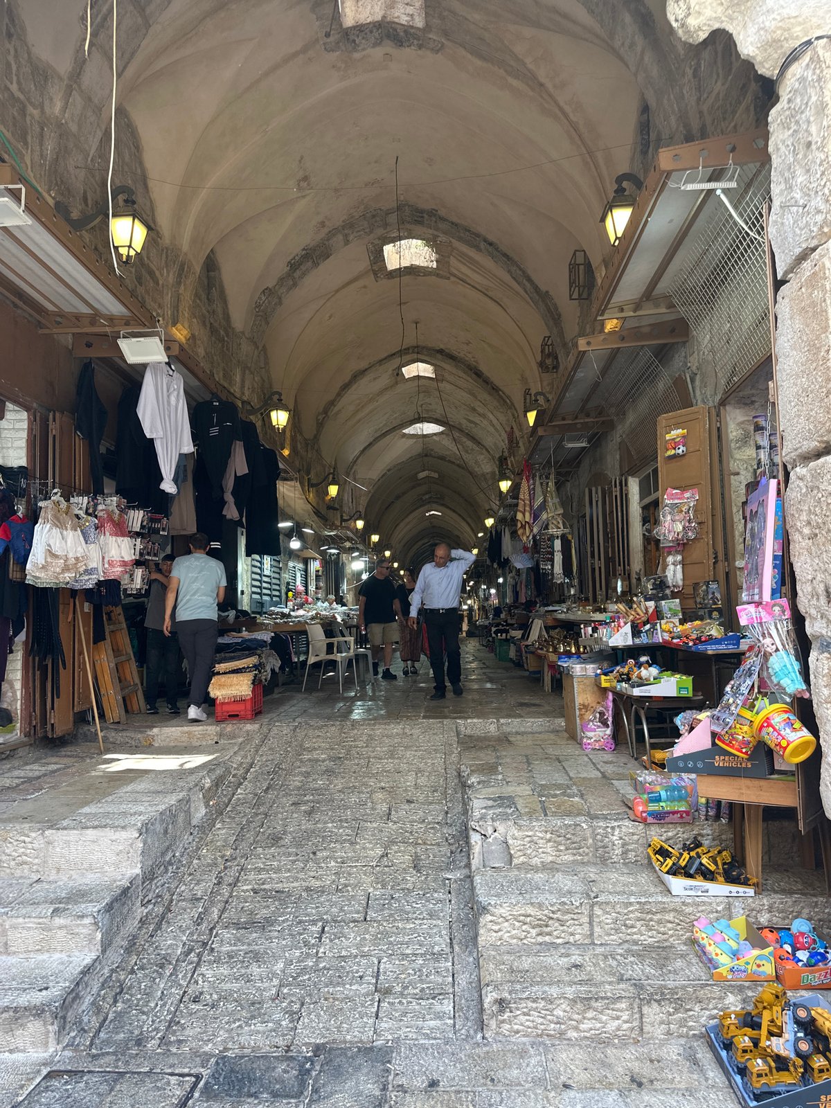 Tourist documents morning walk through Jerusalem Old City markets