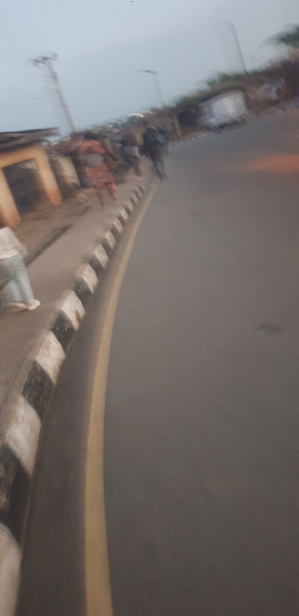 Everyday street life across a dusty Jos neighborhood