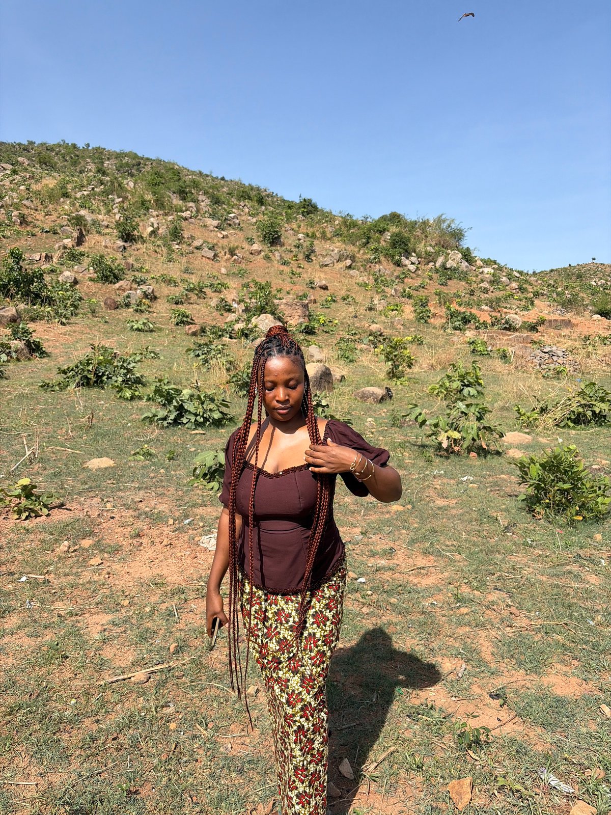 Woman photographed on hillside in Jos, Nigeria