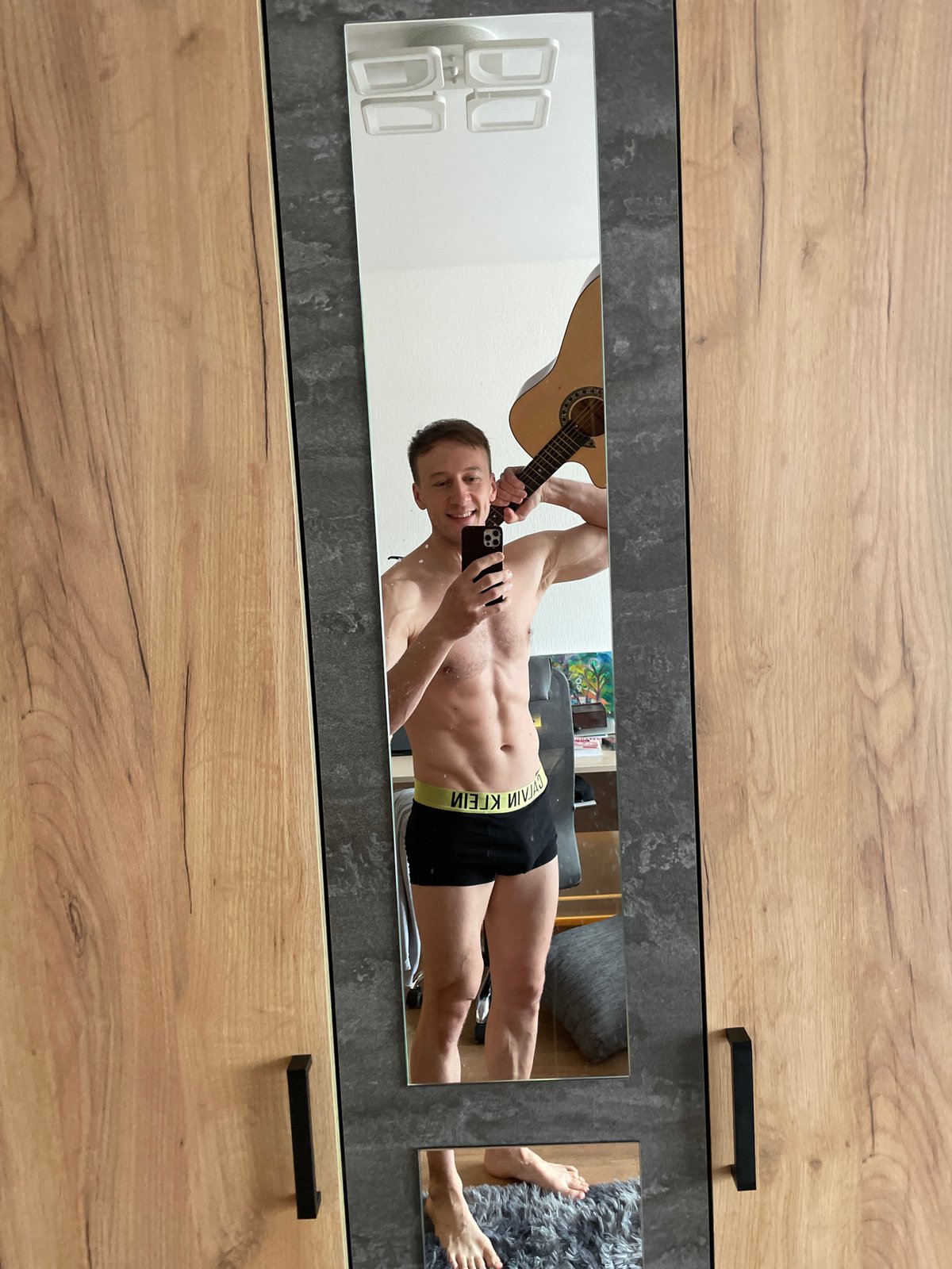 Man takes mirror selfie in Russian indoor location