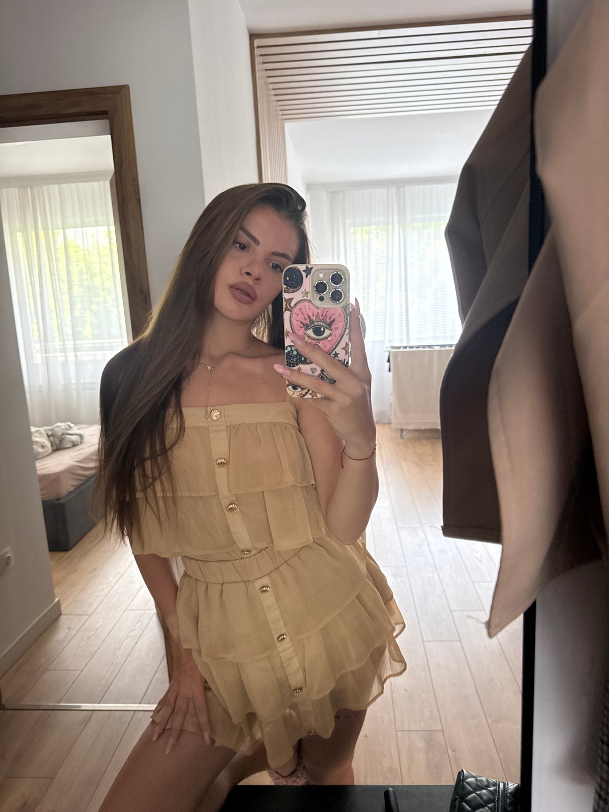 Woman takes sideways mirror selfie indoors