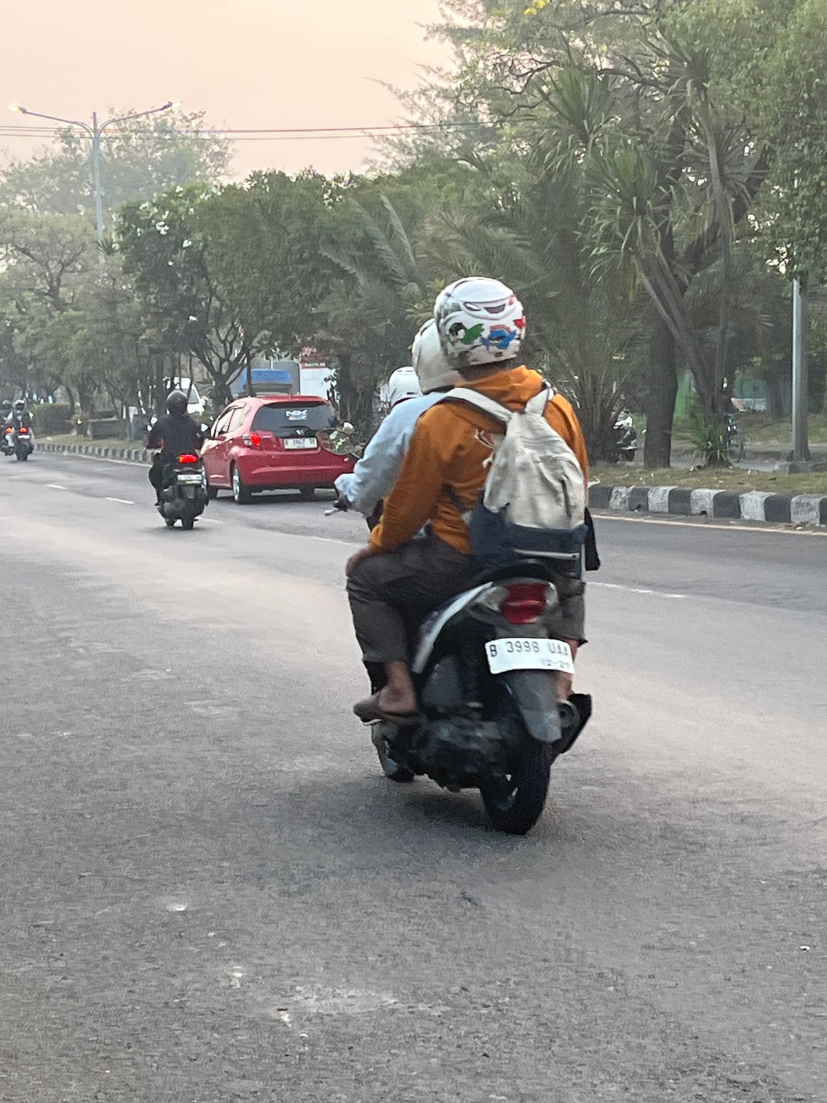 Dense motorcycle traffic flows through East Java streets at night