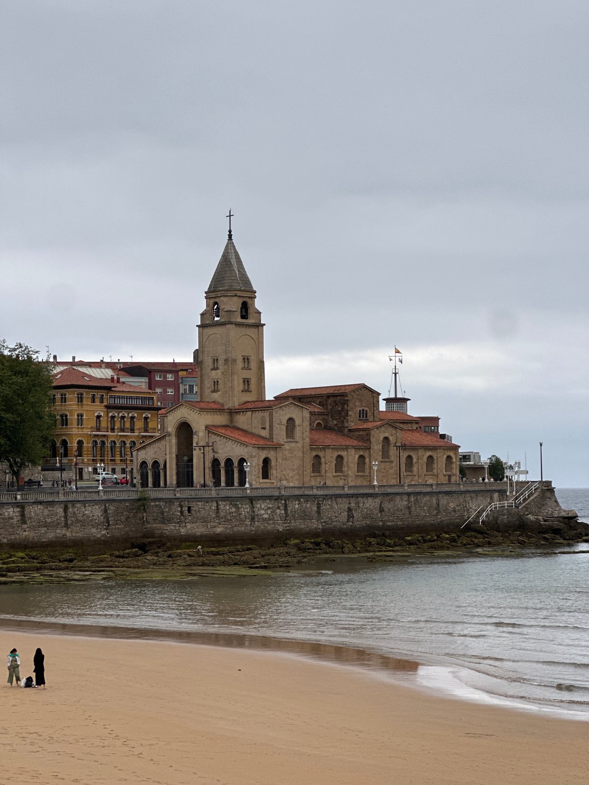 Witness documents historic architecture in Gijón, Spain under cloudy skies