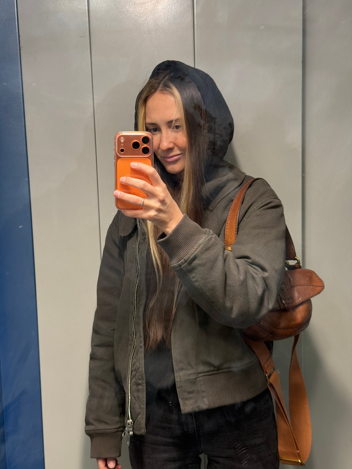 Woman takes mirror selfie in Khimki, Russia