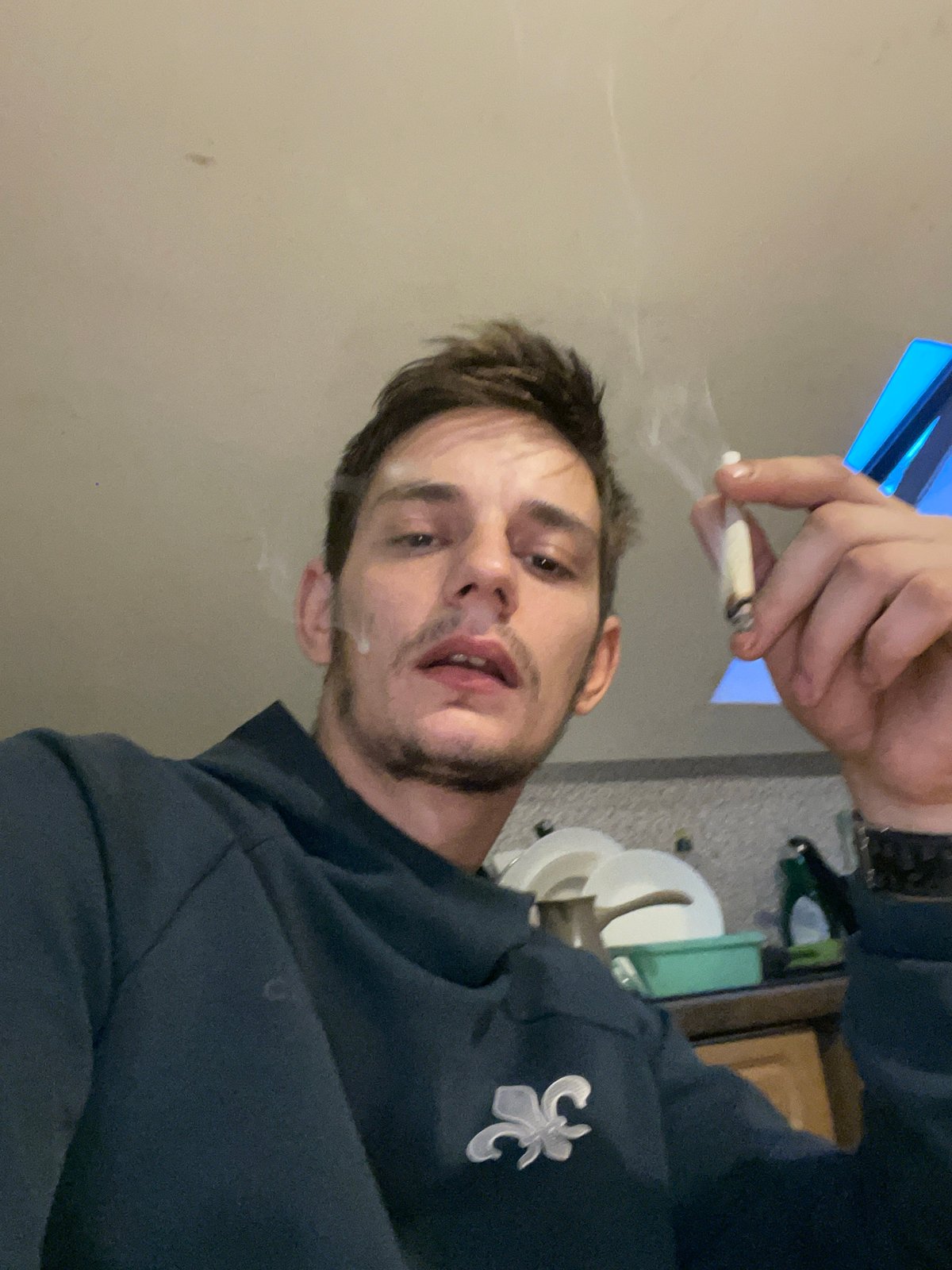 Late-night indoor hangout: smoking, energy drinks, selfies