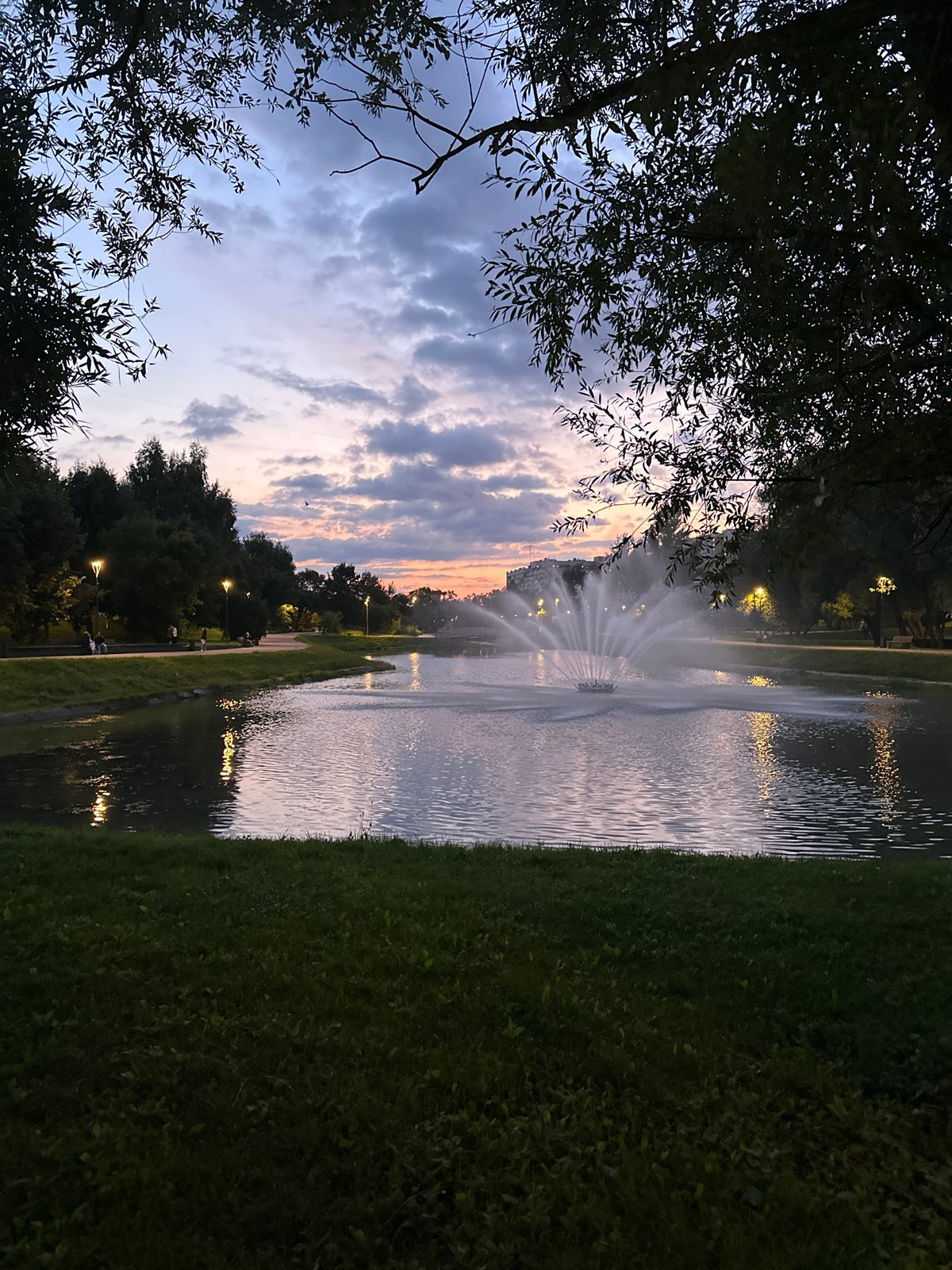 Moscow at dusk: riverside park and city streets in early evening