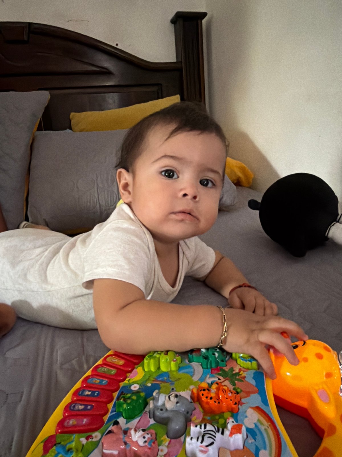 Baby rests on bed in Reforma, Mexico