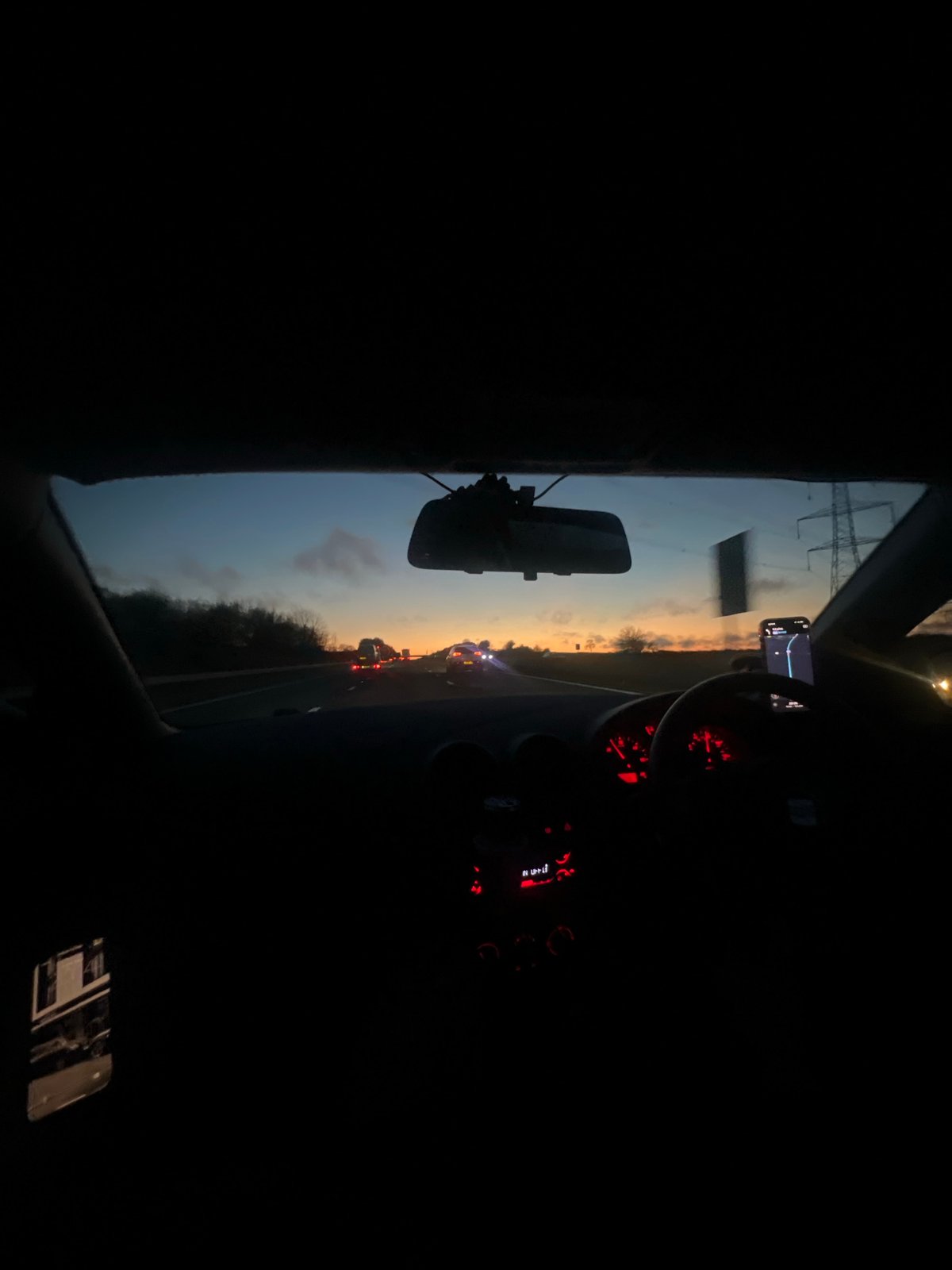 Evening drive captured through windshield in Dodington
