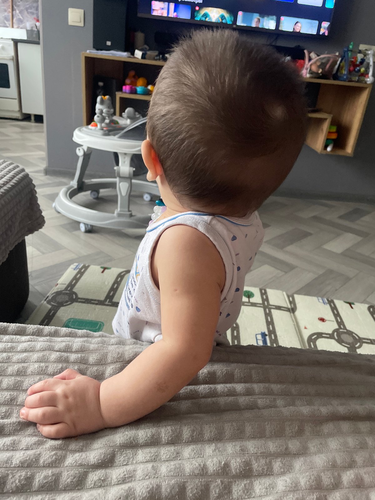 Quiet moments captured in nursery setting with infant and toys