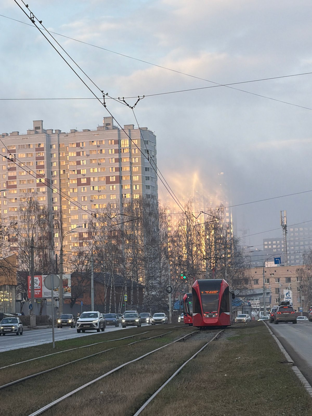 Red tram operates through hazy Izhevsk streets Friday afternoon