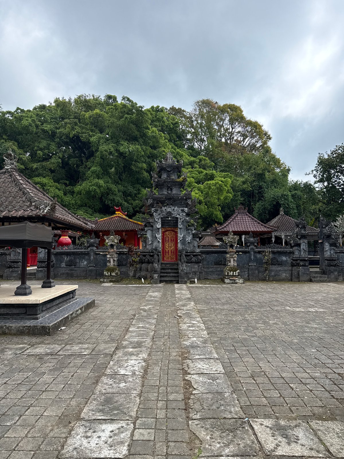 Tourist documents peaceful temple walk through Baturiti forest roads