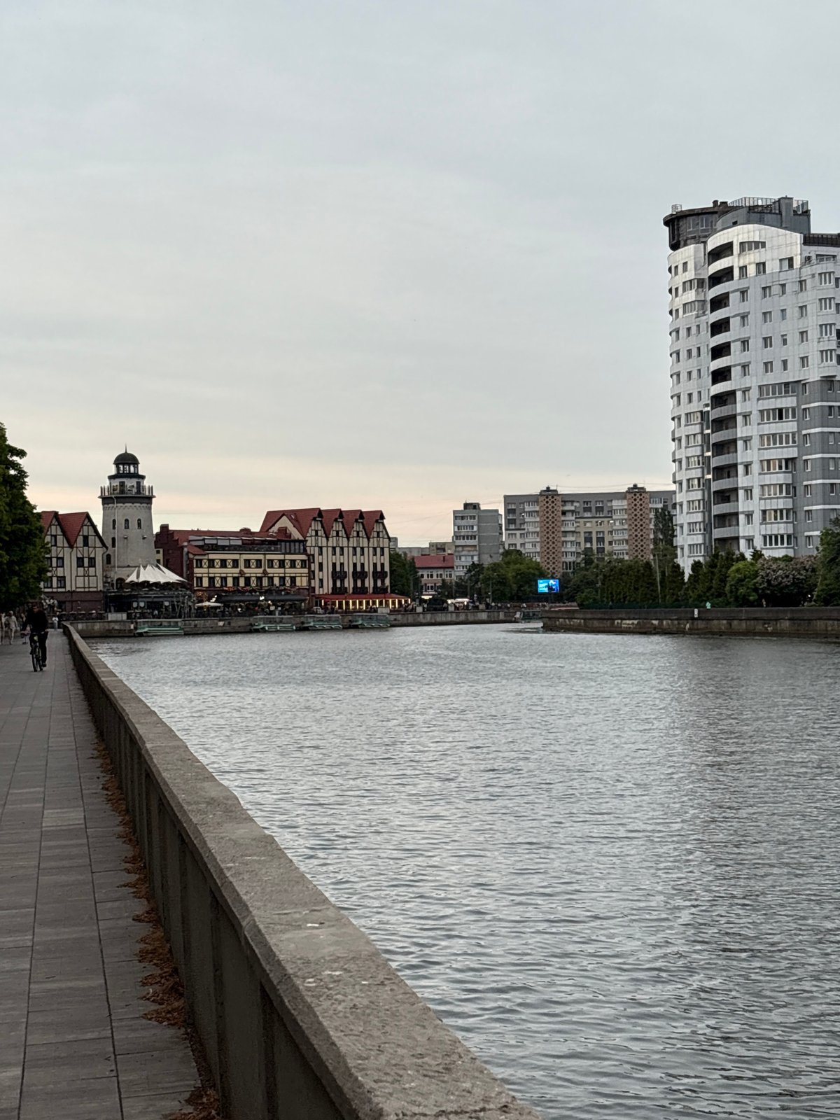 Tourist documents evening walk through historic Kaliningrad cathedral district