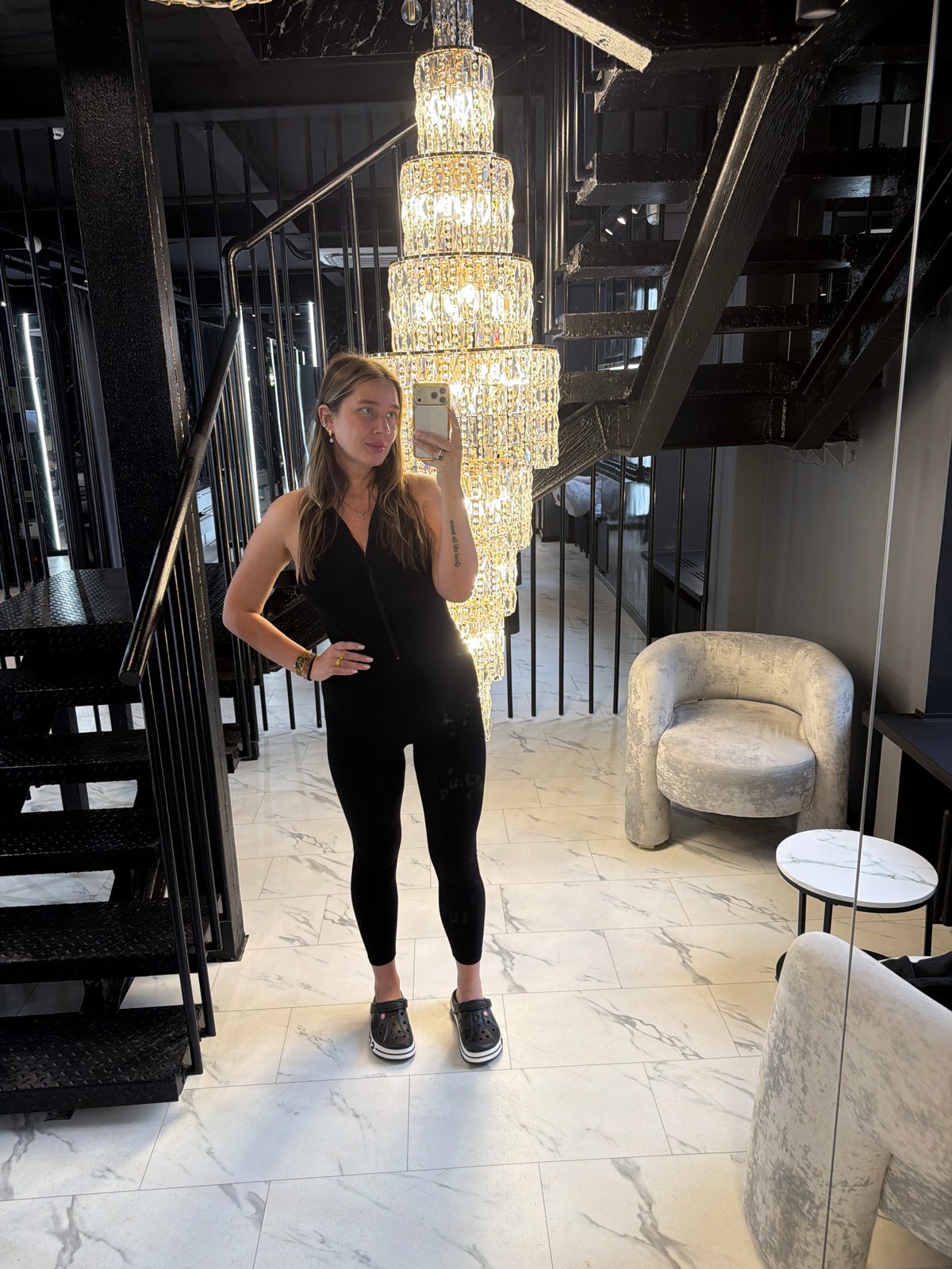 Woman takes selfies under chandelier in upscale Moscow interior