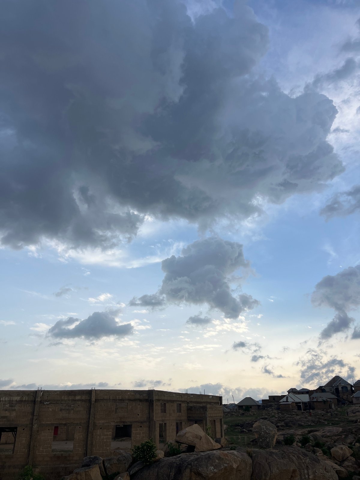 Storm clouds gather over Jos, Nigeria from rocky overlook