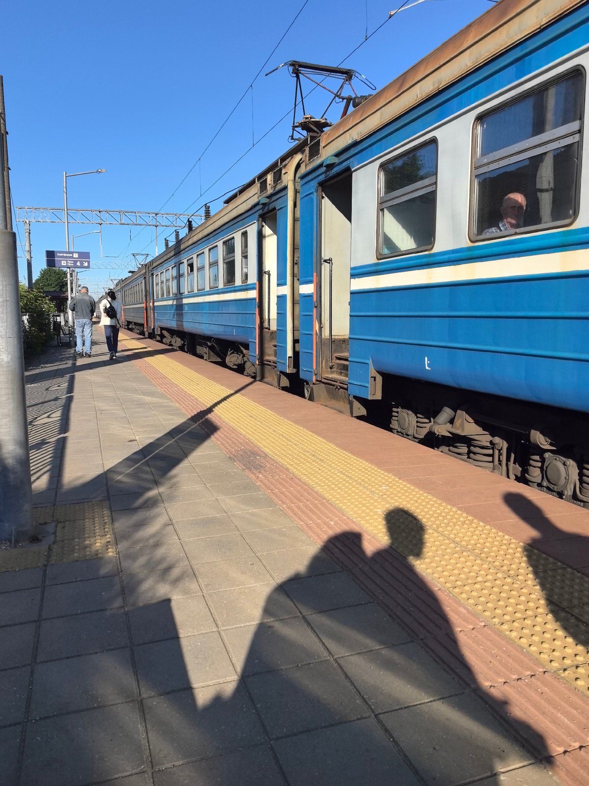 Trains passing through a Belarusian station on a clear morning