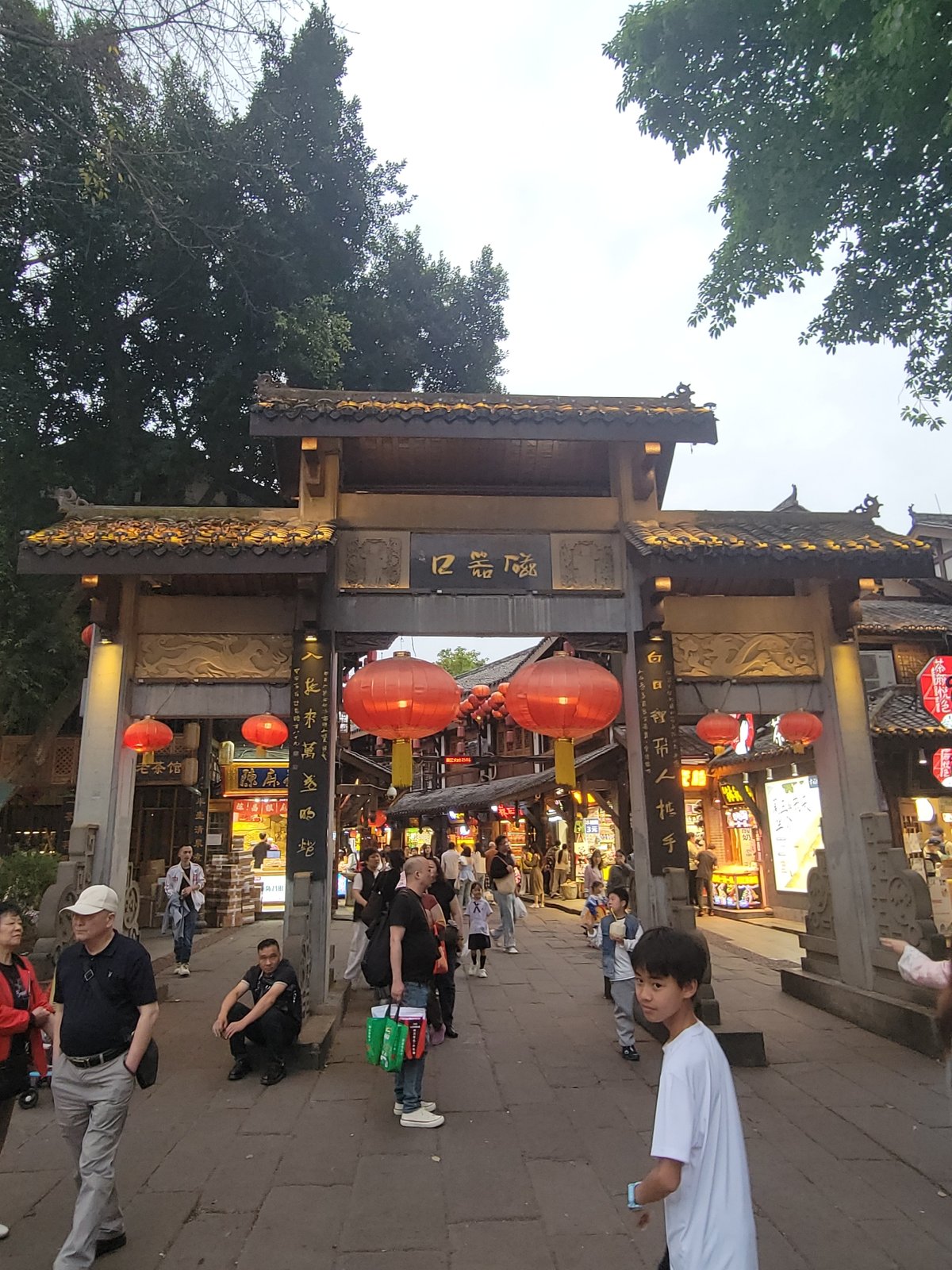 Traditional Chinese street district bustling with pedestrians and vendors