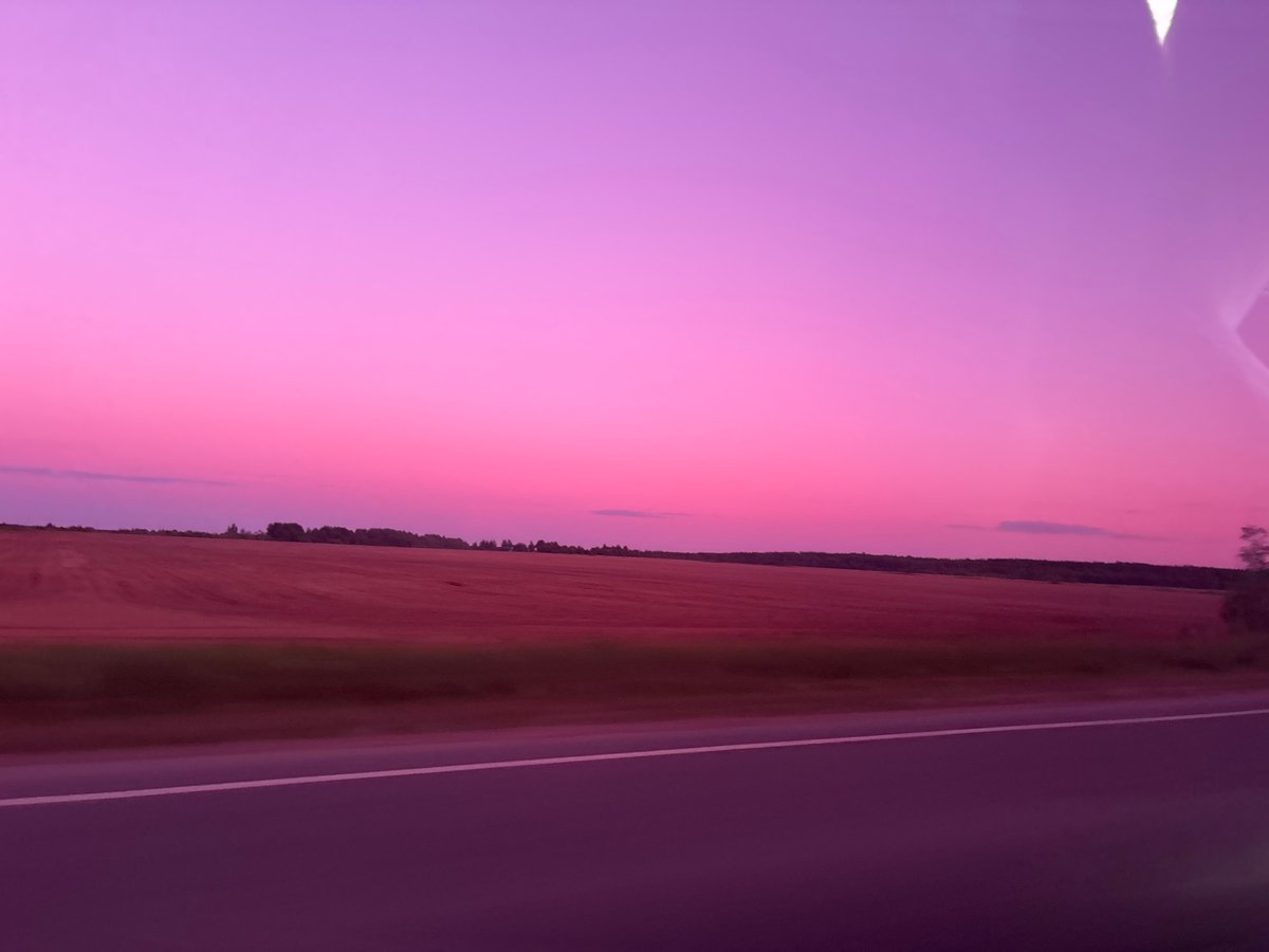 Traveler documents rural Russian sunset during evening drive