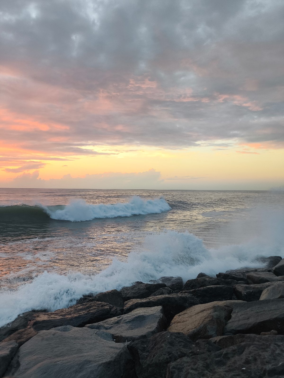 Black Sea sunset breaks over Batumi's rocky Boulevard shore