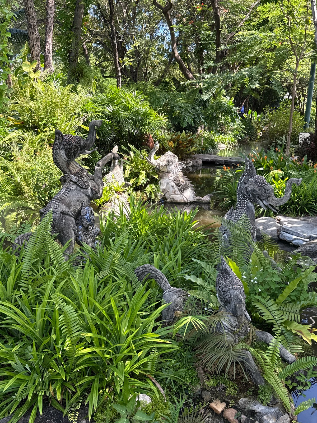 Ornamental garden with elephant statues, peacock sculptures documented in Thailand