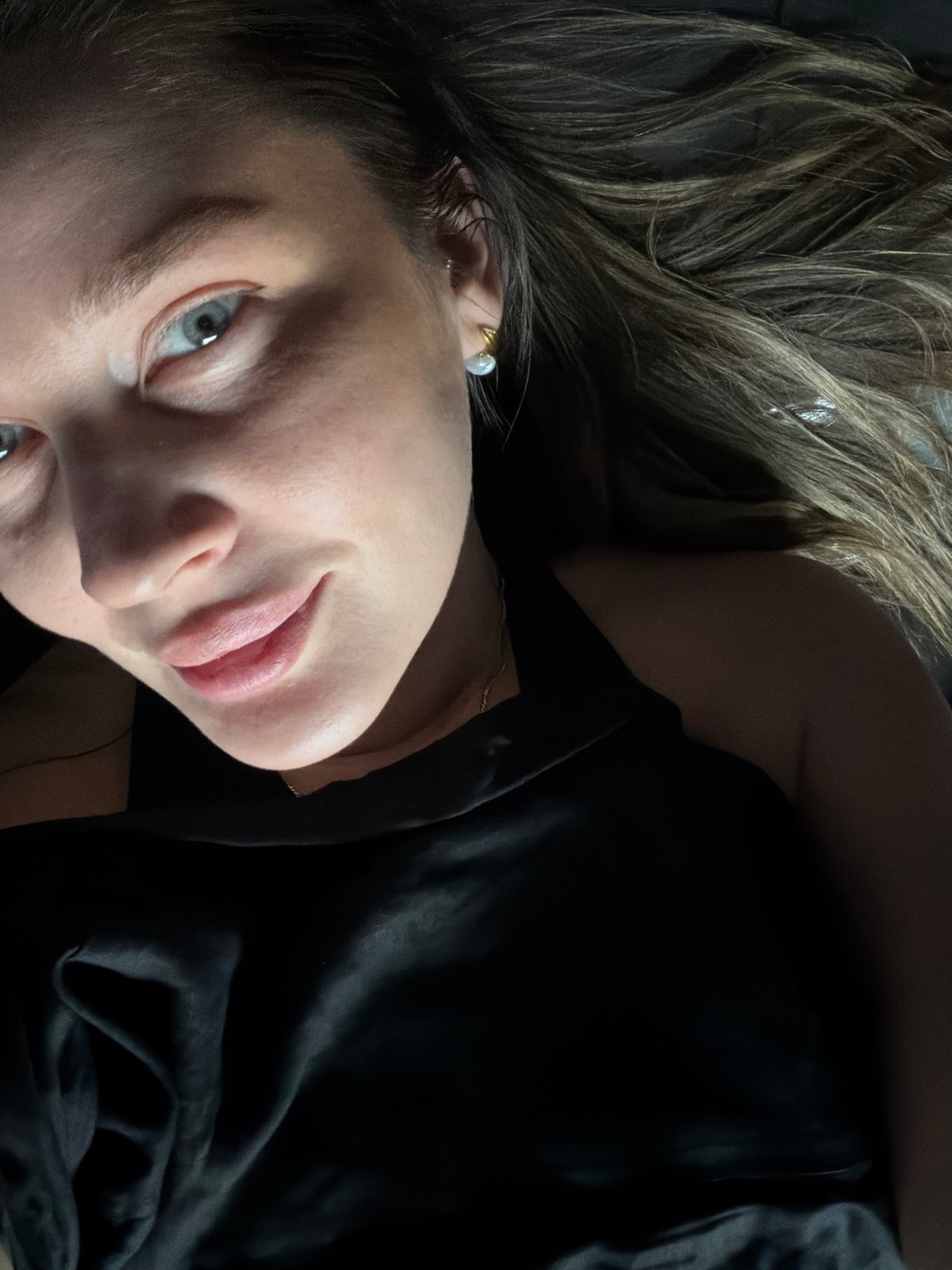 Woman photographed in Moscow wearing black top, rose-gold necklace