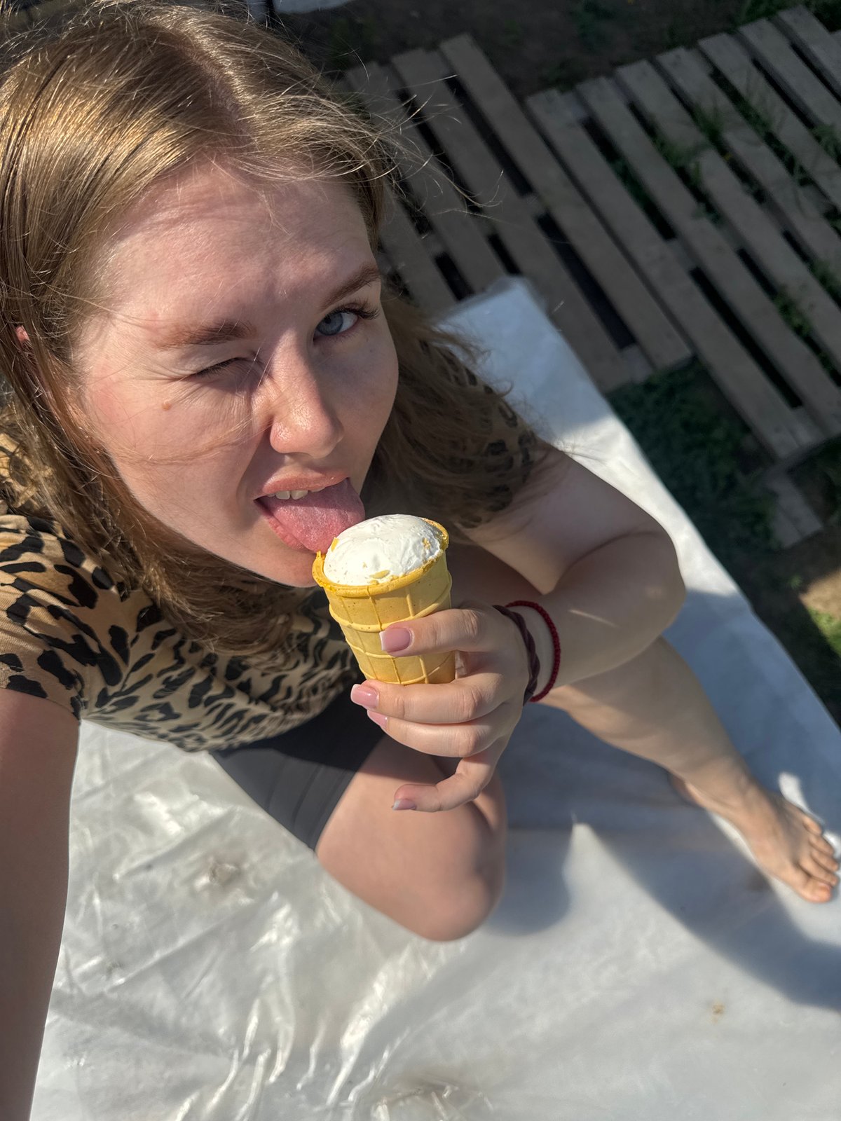 Woman enjoys ice cream on sunny morning in Ферма