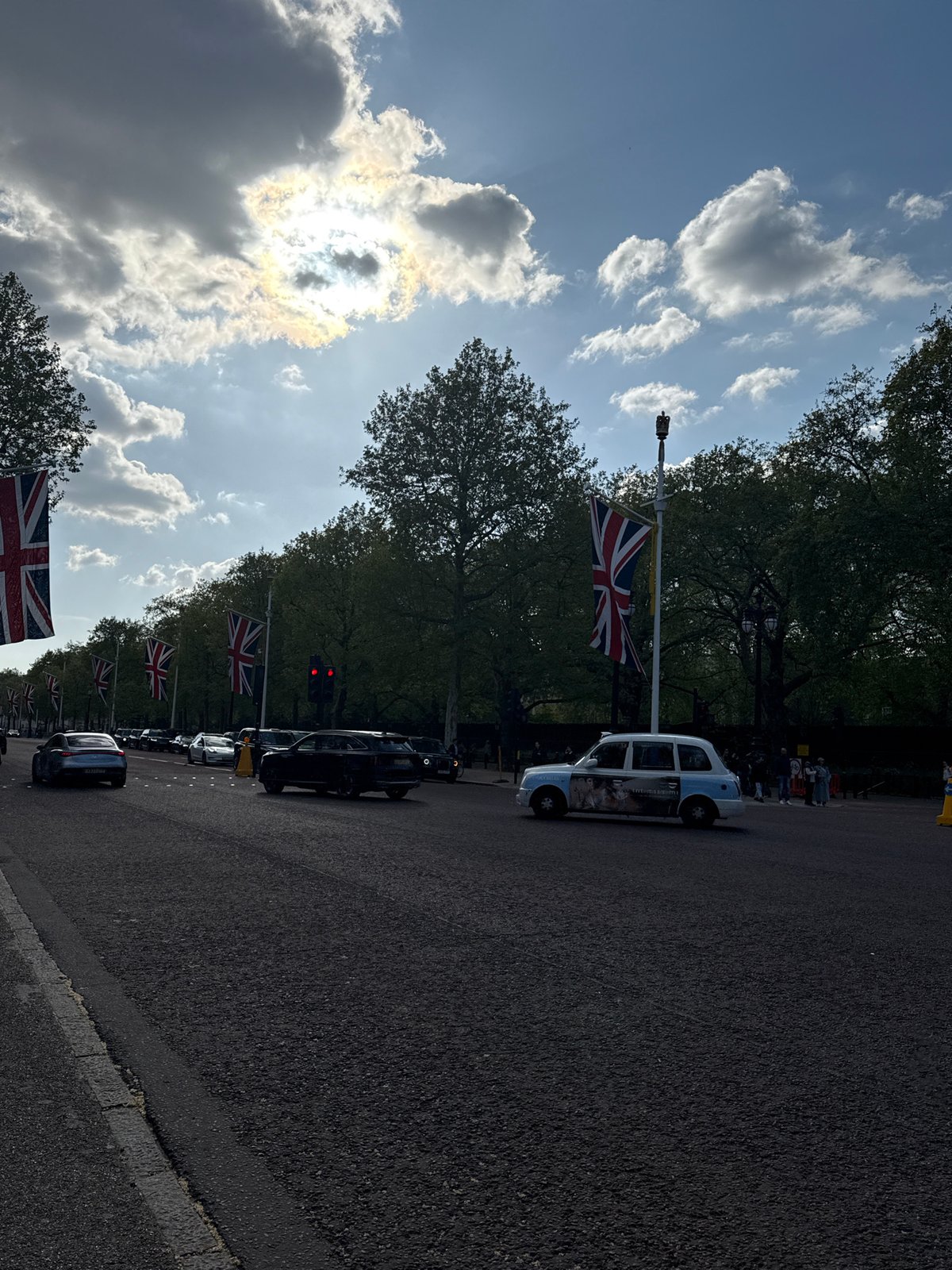 Spring sunshine illuminates flag-decorated Mall in central London