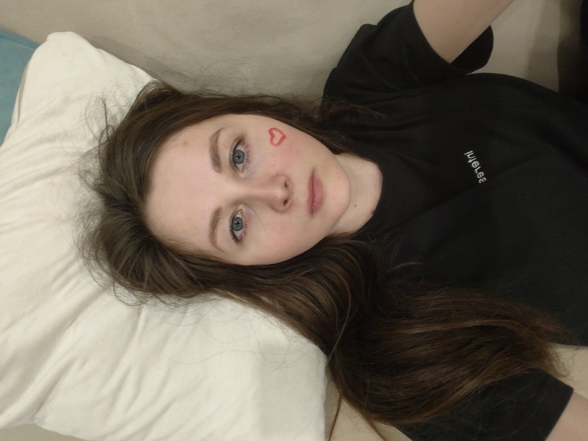Person with heart marking rests on sofa, shadow captured